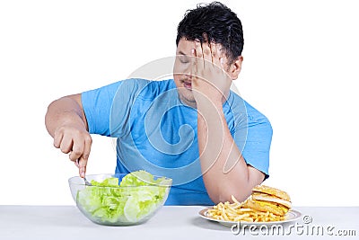 Overweight person chooses to eat salad Stock Photo