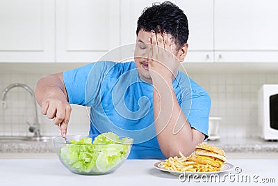Overweight person chooses to eat salad 1 Stock Photo
