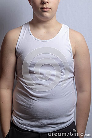 Overweight caucasian teenage boy in a sleeveless top Stock Photo