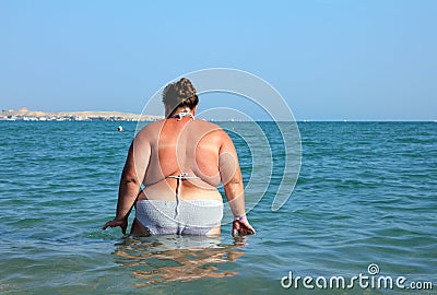 Overweight woman bath in sea Stock Photo