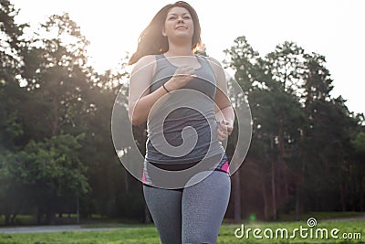 Overweight woman running. Weight loss concept. Stock Photo