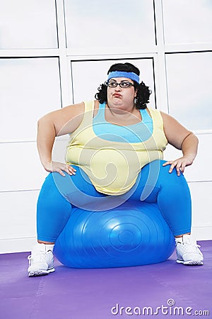 Overweight Woman Sitting On Exercise Ball Stock Photo