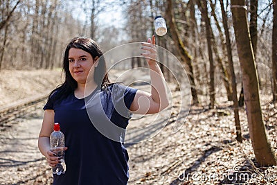 Overweight woman throw out slimming pills and start running outd Stock Photo