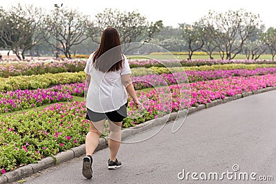 Overweight woman walking in the park Editorial Stock Photo