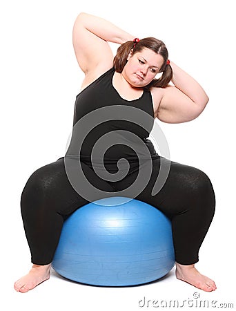Overweight young woman with blue ball. Stock Photo