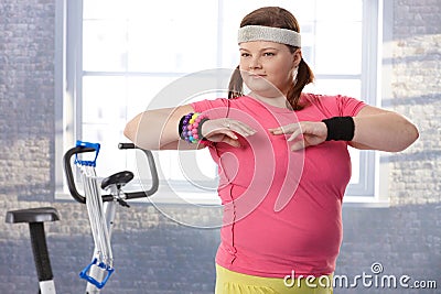 Overweight young woman at the gym Stock Photo