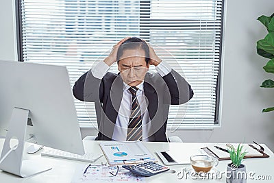 Overwhelmed asian businessman going crazy in office Stock Photo