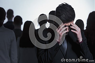 Overwhelmed man against a crowd Stock Photo