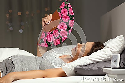Overwhelmed woman fanning suffering heat stroke Stock Photo