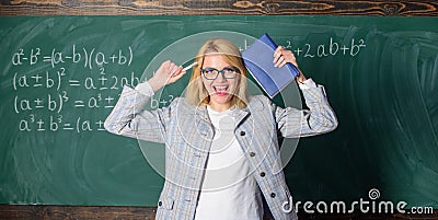 Overwork and lack of support driving teacher out of profession. Teacher stress and burnout. Teacher woman with book Stock Photo