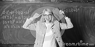 Overwork and lack of support driving teacher out of profession. Teacher stress and burnout. Teacher woman with book Stock Photo