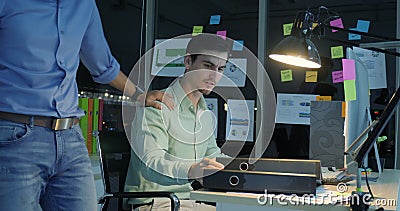 Overworked businessman working late at night in the office. stock footage Overworked businessman working late at night in the office. stock footage