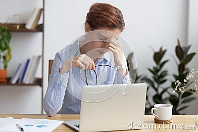 Overworked stressed business woman holding glasses feel eye strain Stock Photo