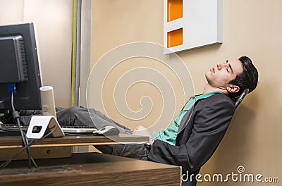 Overworked, tired young businessman sleeping Stock Photo