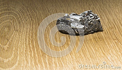 Owl pellet with bones on a wooden background Stock Photo