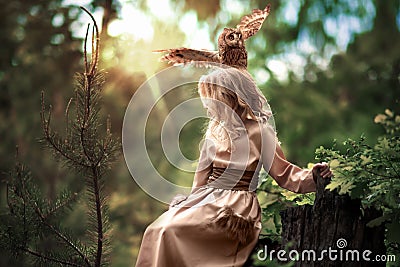 Owl on the girl`s head Stock Photo