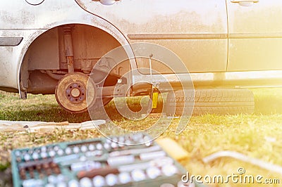 Own repair of car drum brake himself. repair of broken car drum brake disassembled outdoor. flare. Stock Photo