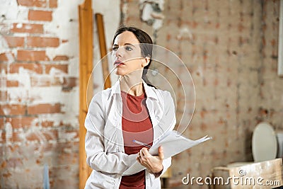 Owner of the apartment checks the completed repair work according to plan Stock Photo