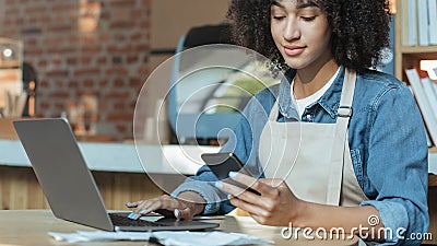 Owner of coffee business works in accounting with social media Stock Photo