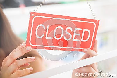 Owner Holding Closed Sign In Clothing Store Stock Photo