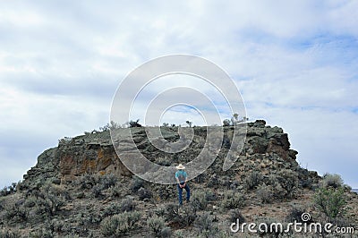 Owyhee Canyonlands Wilderness near Shoofly Oolite man walking up rock horizontal Editorial Stock Photo