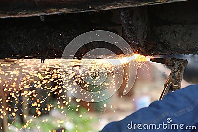 Oxy-Acetylene torch cutting through steel hull Stock Photo