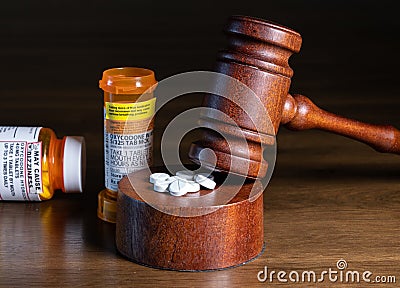 Oxycodone opioid tablets with judge gavel for court decision about liability Stock Photo