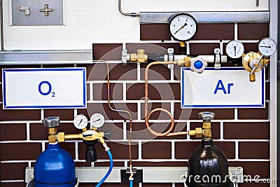 Oxygen and argon cylinders and manometers Stock Photo