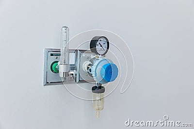 Oxygen flow meter plugged in the green outlet on hospital wall, Medical equipment. Oxygen for patients in the wall. Oxygen Gas Pip Stock Photo