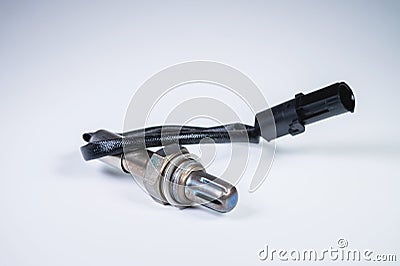 The oxygen sensor is a new lambda sensor. Spare parts on the car on a gray gradient background Stock Photo