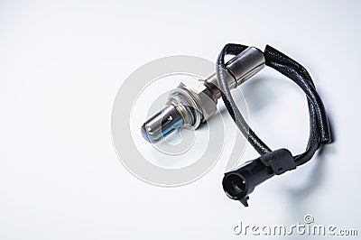The oxygen sensor is a new lambda sensor. Spare parts on the car on a gray gradient background Stock Photo