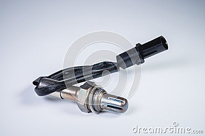 The oxygen sensor is a new lambda sensor. Spare parts on the car on a gray gradient background Stock Photo