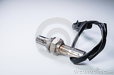 The oxygen sensor is a new lambda sensor. Spare parts on the car on a gray gradient background Stock Photo