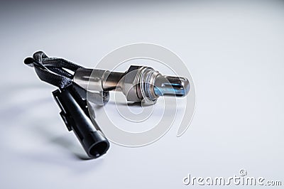 The oxygen sensor is a new lambda sensor. Spare parts on the car on a gray gradient background Stock Photo