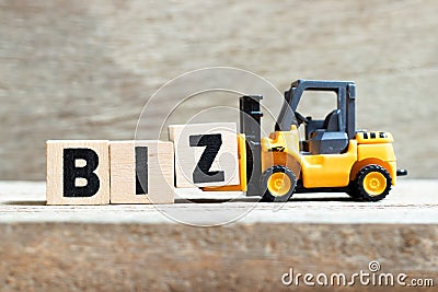 oy forklift hold letter block Z to word biz Abbreviation of business on wood background Stock Photo