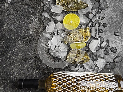 Oyster on ice, lemon slices, wine bottle. Delicatessen and gourment food, rich in iodine, antioxidants, zinc Stock Photo