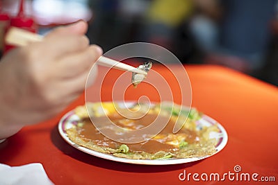 Oyster Omelet and chopsticks .taiwanese food Stock Photo