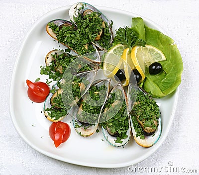 Oysters with lemon and tomatoes Stock Photo