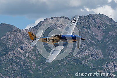 P-51 Mustang Performing Aerobatics at Hill AFB in blue sky above Wasatch Mountains Editorial Stock Photo