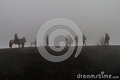 PACAYA, GUATEMALA - MAR 28, 2016: Tourists visiting the Pacaya volcano in the mist, Guatema Editorial Stock Photo