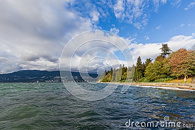 Pacific coastline seawall pathway and fresh green garden of Stanley park with blue sky in summer sunset at Vancouver of British Stock Photo