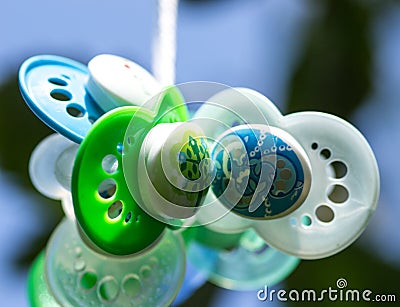 Pacifiers in a tree Stock Photo