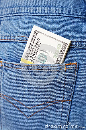Pack of dollars sticking out of a jeans pocket Stock Photo