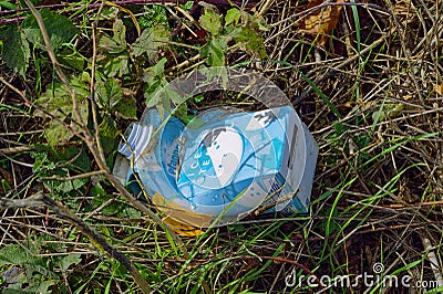 Pack of ice tea that was thoughtlessly disposed of as waste in nature Editorial Stock Photo