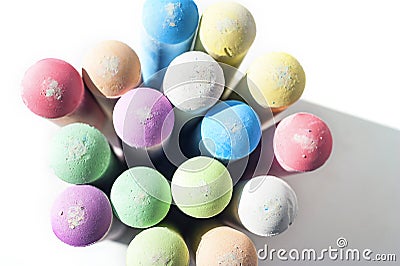 Pack of Jumbo Sidewalk Chalk, Assorted Colors, Bold Tips Casting Shadow on White Background. Top View Stock Photo