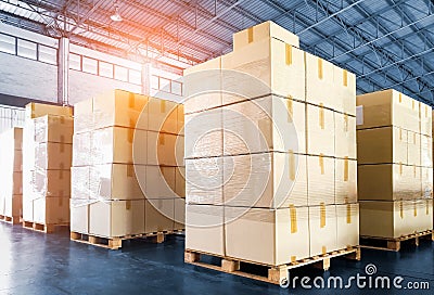 Package Boxes Stacked on Wooden Pallets in Warehouse. Cargo Supplies Warehouse Shipping. Shipment Boxes, Supply Chain. Stock Photo