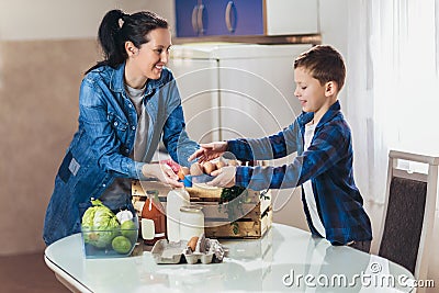 Package of fresh groceries to a stay-at-home mother and her son. Stock Photo