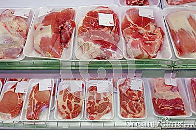 Packaged meat on supermarket shelves Stock Photo