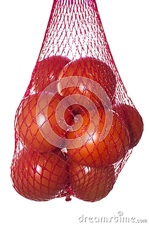 Packaged tomatoes hanging in red plastic net Stock Photo