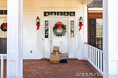 Packages on front porch of home during holiday season Stock Photo